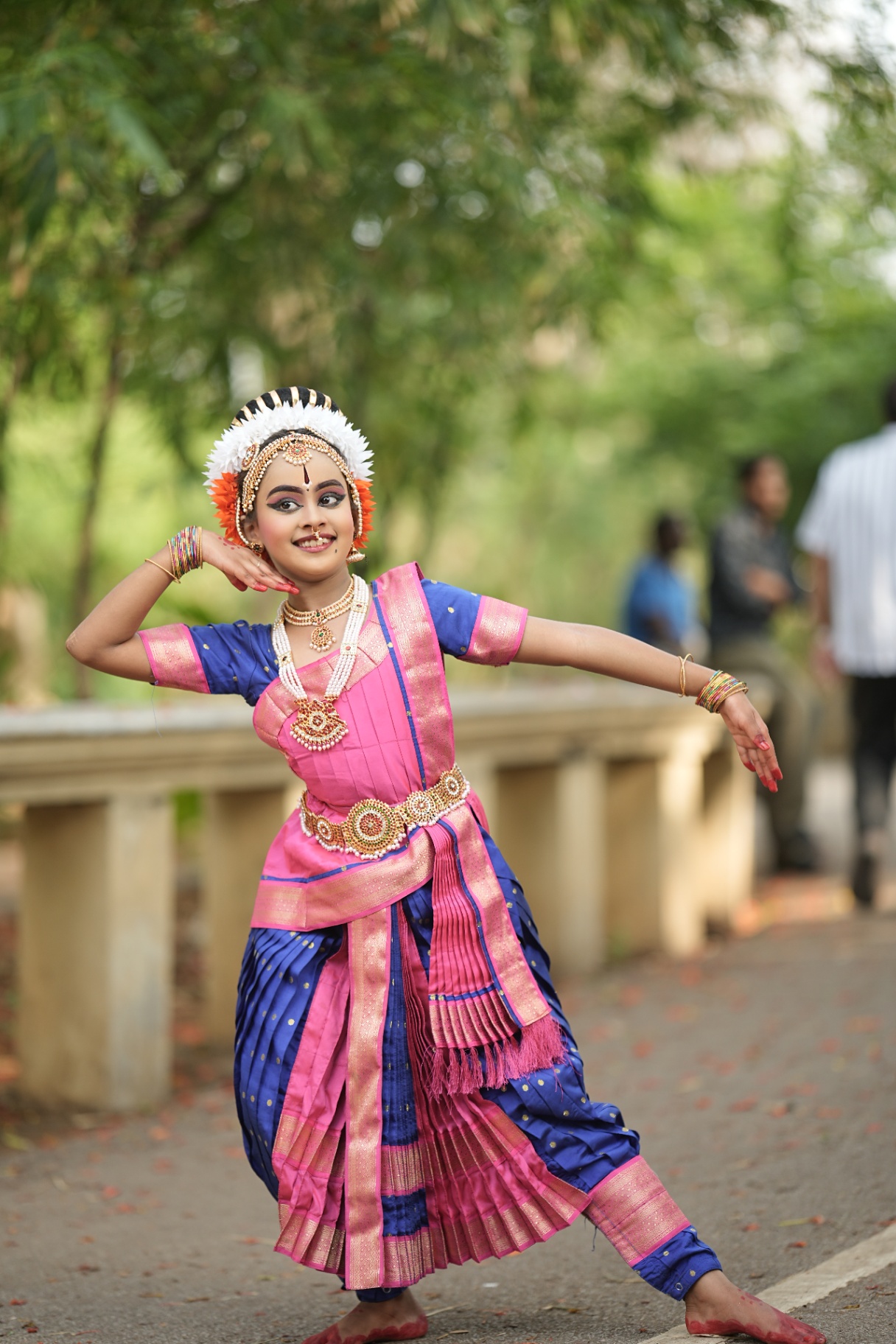 Solo student in pink and blue silk in a classical pose