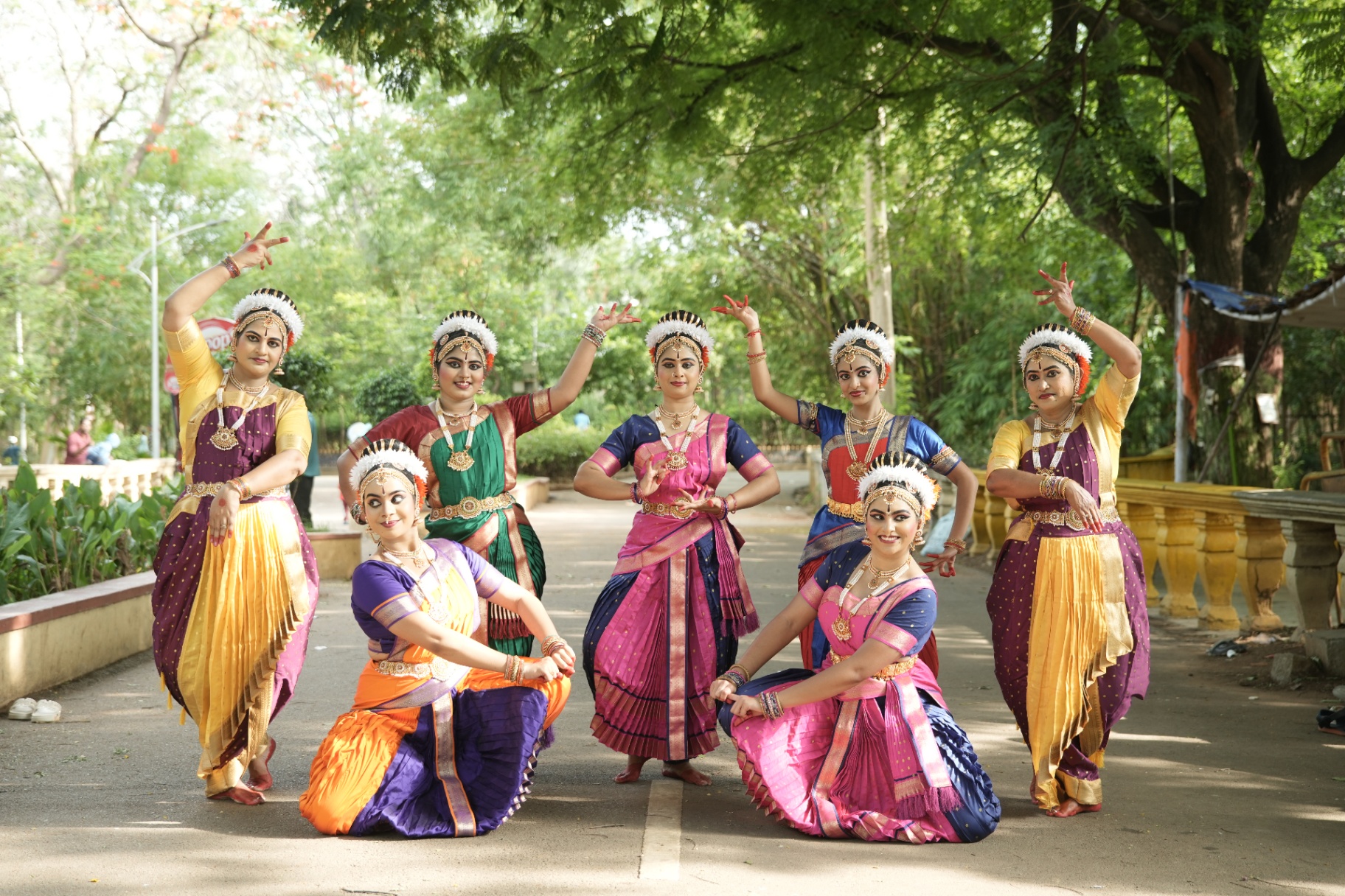 Seven dancers in graceful synchronized formation outdoors