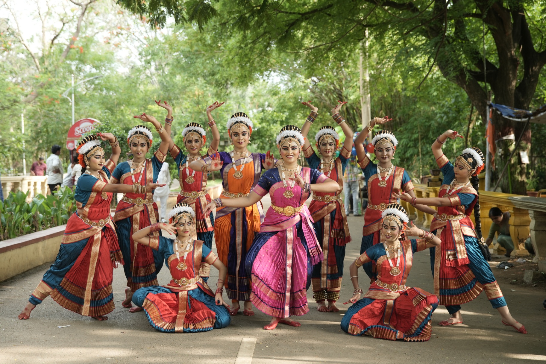 Senior students posing together in vibrant silk costumes